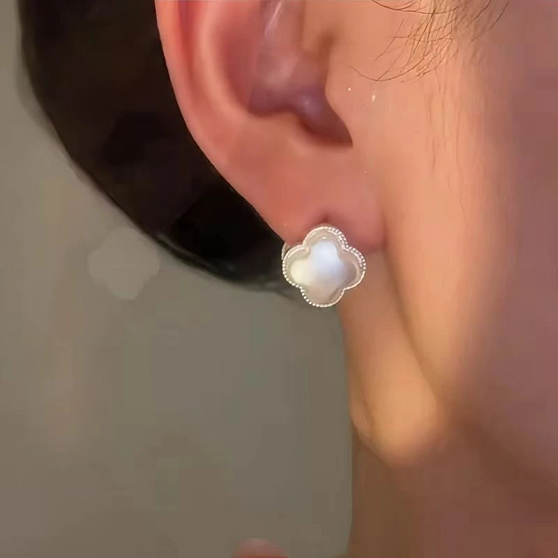 Model showcasing the dangle and style of the 14K Gold-Plated Luxury Zircon Diamond Four-Leaf Flower Earrings