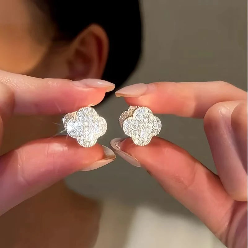 Angled view of the 14K Gold-Plated Luxury Zircon Diamond Four-Leaf Flower Earrings