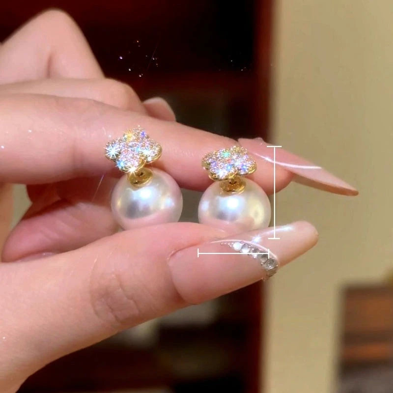 Model showcasing the dangle and style of the 14K Gold-Plated Luxury Zircon Diamond Four Leaf Flower Bead Jacket Earrings