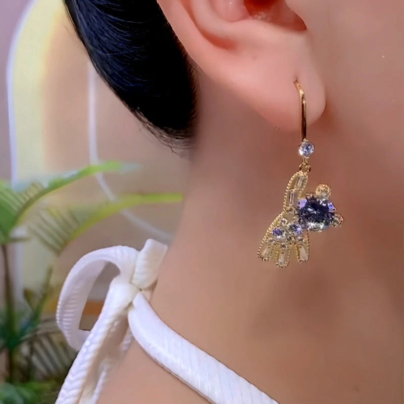 Model showcasing the dangle and style of the 14K Gold-Plated Luxury Zircon Diamond Golden Bear Ear Hook Earrings