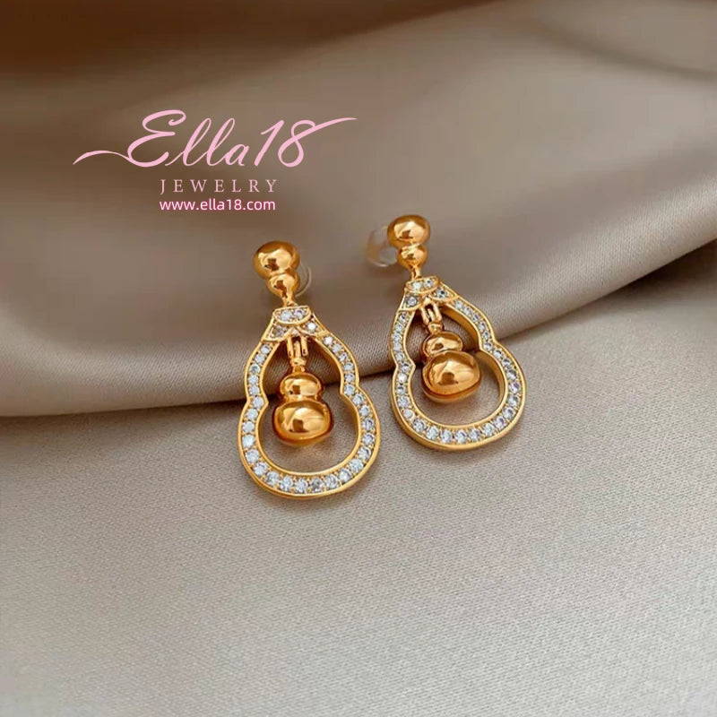 Model showcasing the dangle and style of the 14K Gold-Plated Luxury Zircon Diamond Gourd Earrings