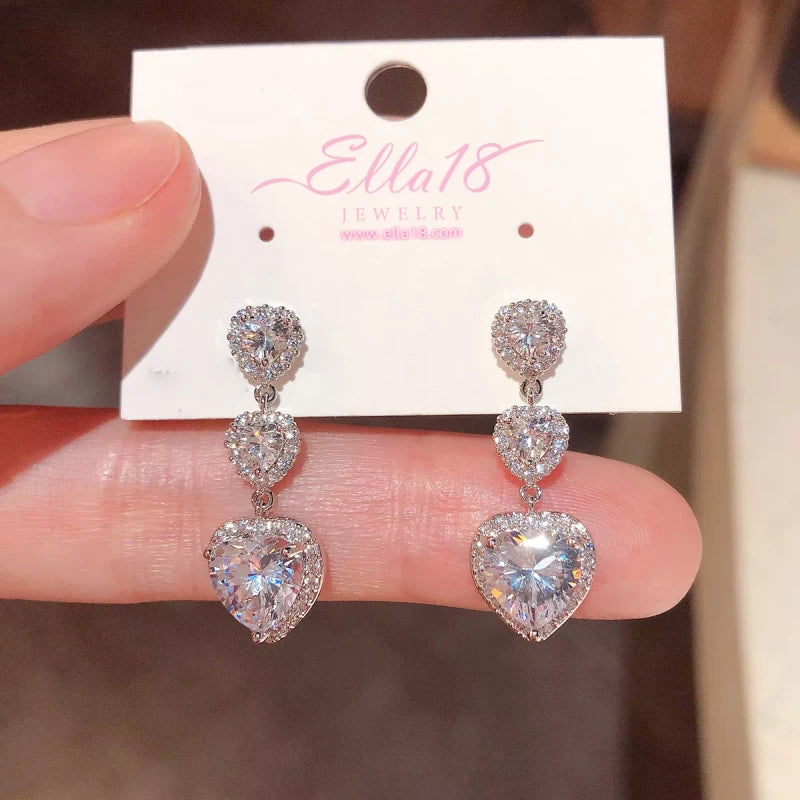 Model showcasing the dangle and style of the 14K Gold-Plated Luxury Zircon Diamond Heart Tassel Earrings