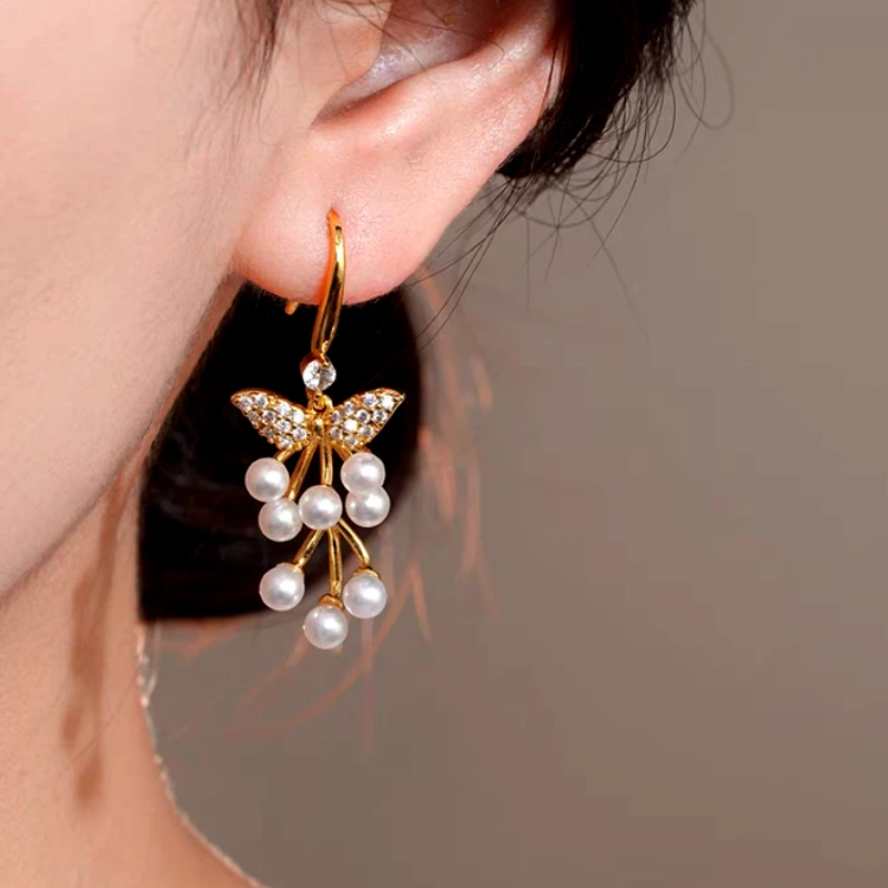 Angled view of the 14K Gold-Plated Luxury Zircon Diamond Pearl Tassel Ear Hook Earrings