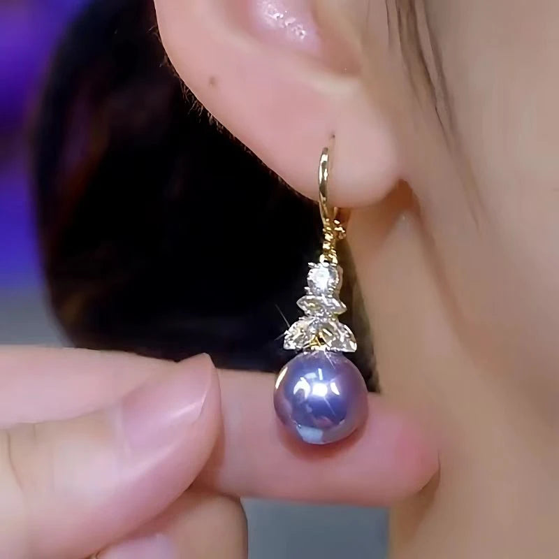 Model showcasing the dangle and style of the 14K Gold-Plated Luxury Zircon Diamond Purple Pearl Earrings