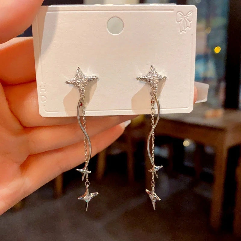 Angled view of the 14K Gold-Plated Luxury Zircon Diamond Star Tassel Earrings
