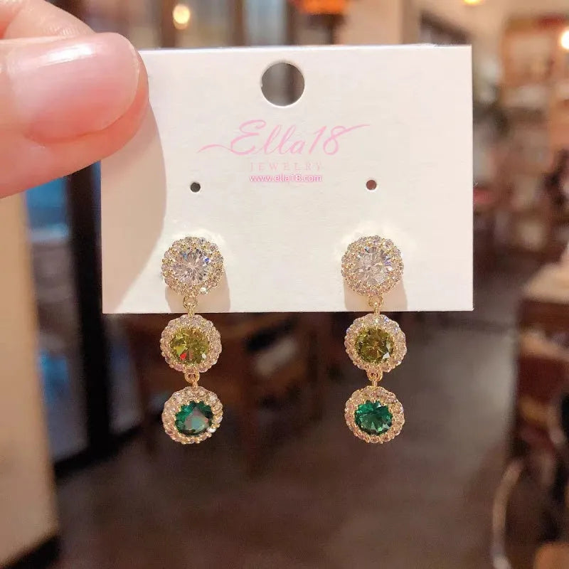 Close-up detail of the sparkling zircons and plating on the Green Tassel Earrings