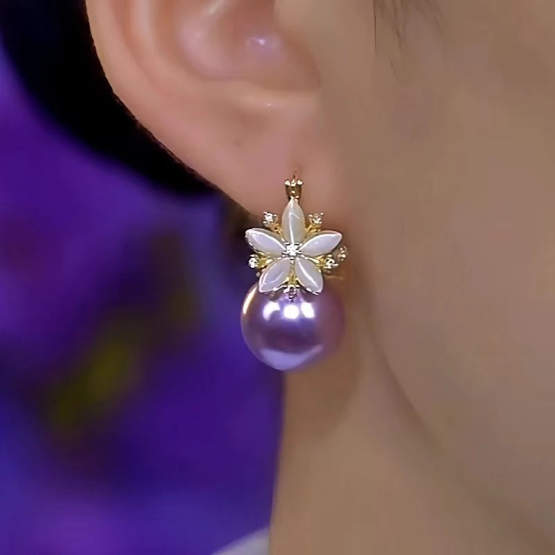 Model showcasing the dangle and style of the 14K Gold-Plated Luxury Zircon Double-Sided Flower Purple Pearl Earrings
