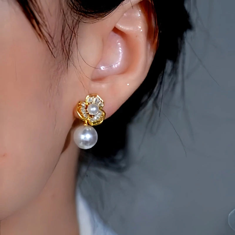 Model showcasing the dangle and style of the 14K Gold-Plated Luxury Zircon Flower Pearl Earrings