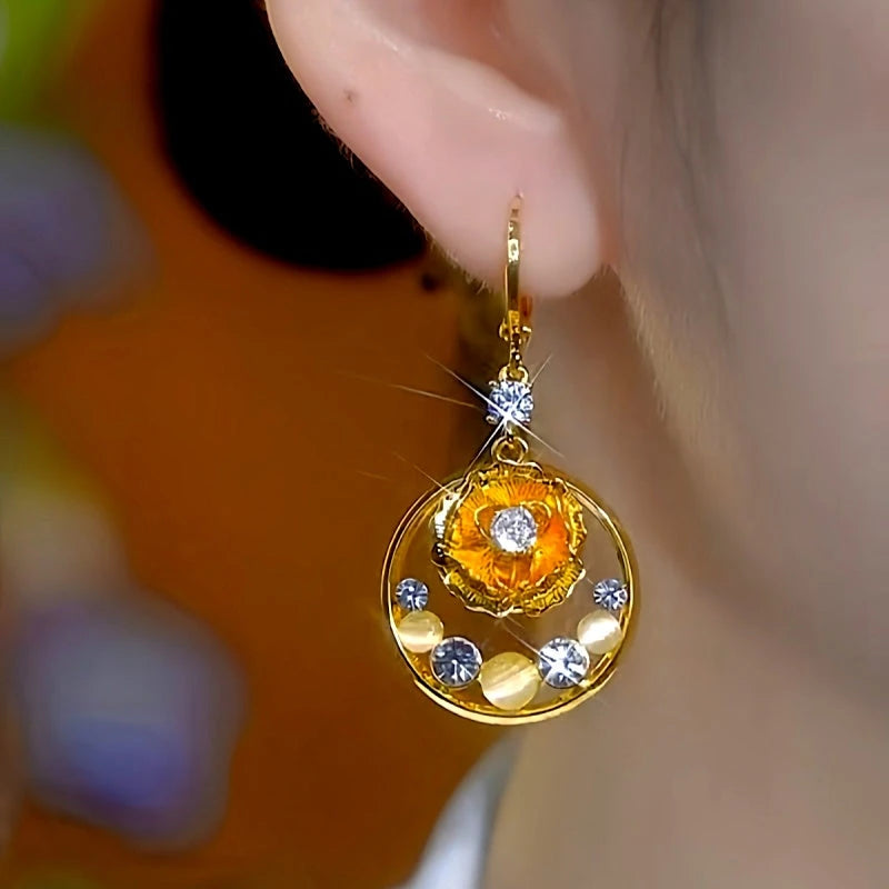 Model showcasing the dangle and style of the 14K Gold-Plated Luxury Zircon Flower Tassel Earrings
