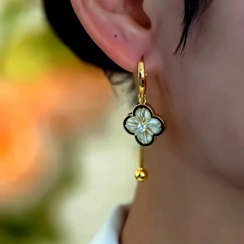 Close-up detail of the sparkling zircons and plating on the Clover Tassel Earrings