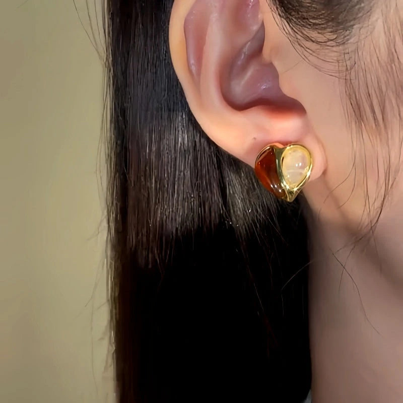 Model showcasing the dangle and style of the 14K Gold-Plated Luxury Zircon Heart Stud Earrings