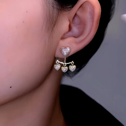 Model showcasing the dangle and style of the 14K Gold-Plated Luxury Zircon Heart Tassel Earrings