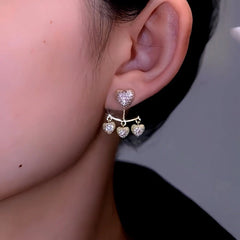 Model showcasing the dangle and style of the 14K Gold-Plated Luxury Zircon Heart Tassel Earrings