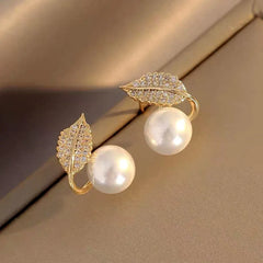 Model showcasing the dangle and style of the 14K Gold-Plated Luxury Zircon Leaf Pearl Stud Earrings