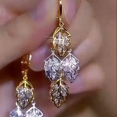 Model showcasing the dangle and style of the 14K Gold-Plated Luxury Zircon Leaf Tassel Earrings