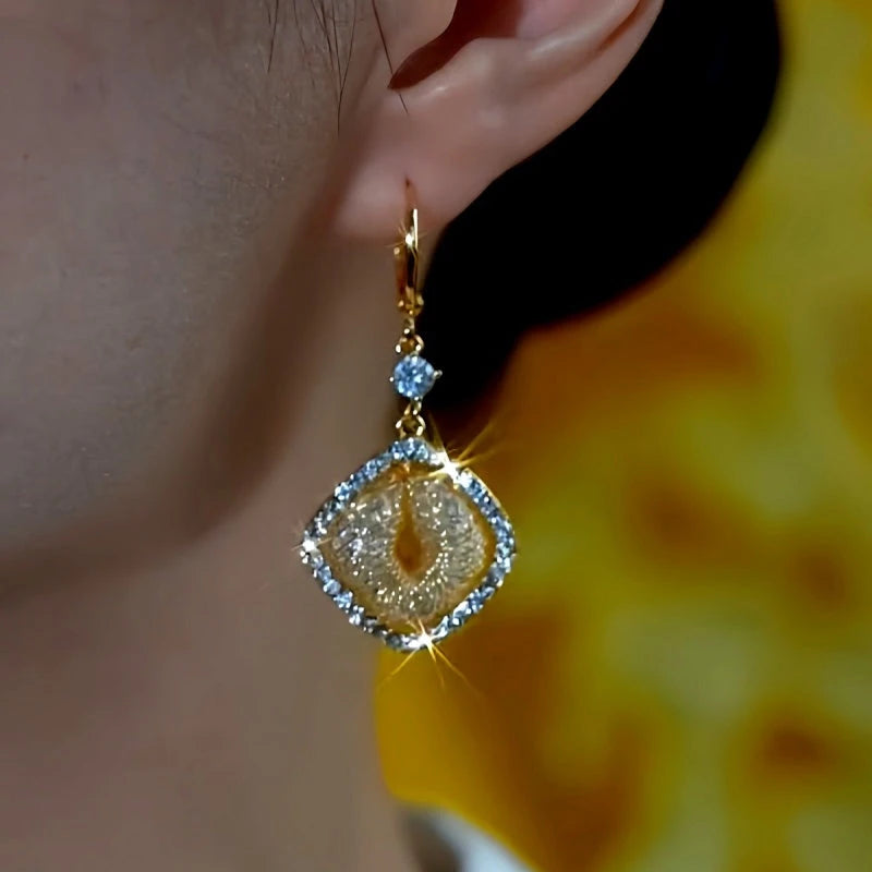 Model showcasing the dangle and style of the 14K Gold-Plated Luxury Zircon Mesh Square Earrings