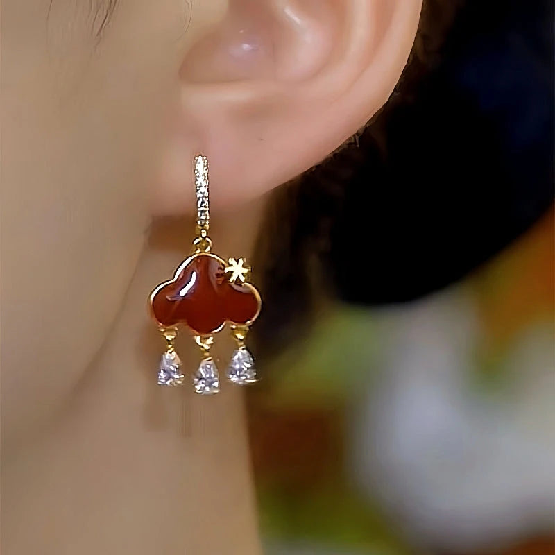 Model showcasing the dangle and style of the 14K Gold-Plated Luxury Zircon Peace Lock Earrings