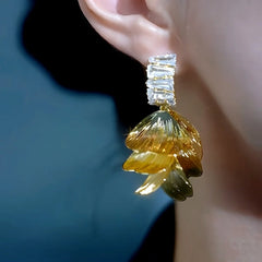Model showcasing the dangle and style of the 14K Gold-Plated Luxury Zircon Petal Flower Earrings