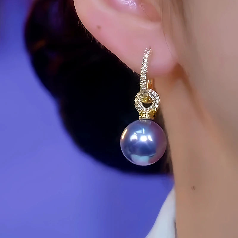 Model showcasing the dangle and style of the 14K Gold-Plated Luxury Zircon Purple Pearl Earrings