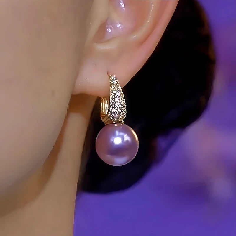 Model showcasing the dangle and style of the 14K Gold-Plated Luxury Zircon Purple Pearl Earrings