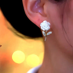 Model showcasing the dangle and style of the 14K Gold-Plated Luxury Zircon White Rose Earrings