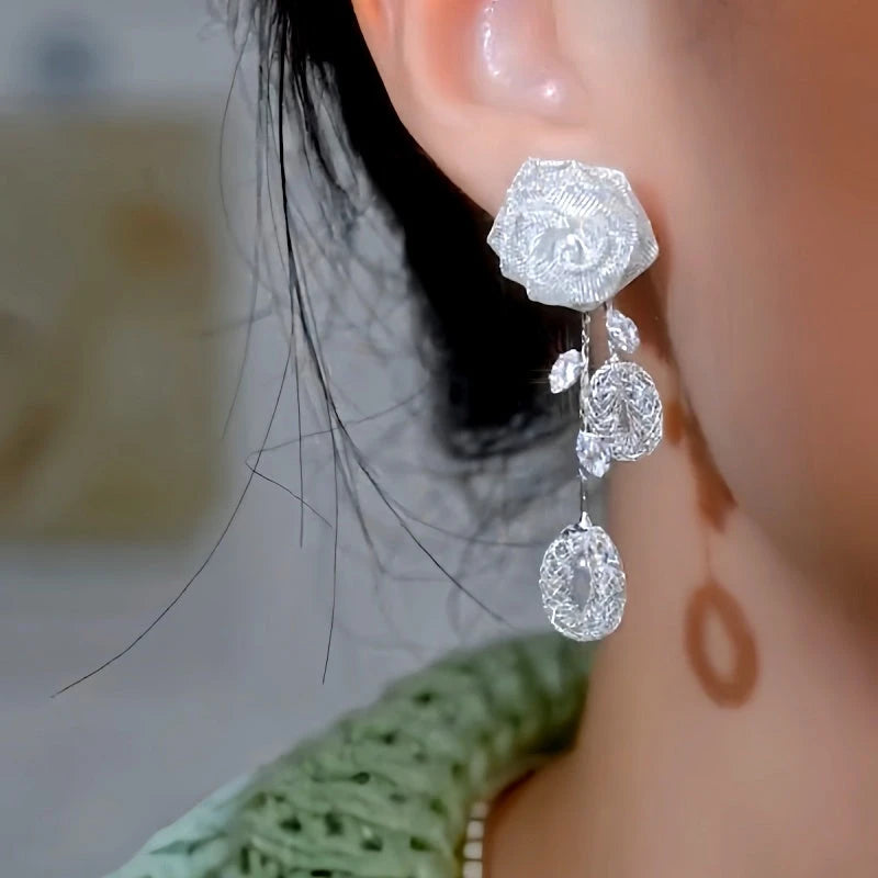 Model showcasing the dangle and style of the 14K Gold-Plated Luxury Zorcon Rose Tassel Earrings