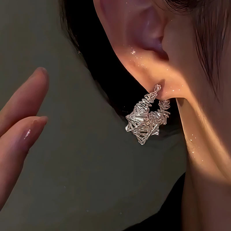 Close-up detail of the sparkling zircons and plating on the Silver Winding Earrings