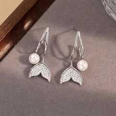 Pair of Silver Pave Mermaid Tail Pearl Drop Earrings Flat Lay