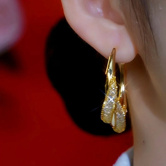 Model showcasing the dangle and style of the 14K Gold-Plated Mesh Hoop Earrings