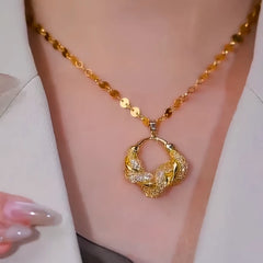 Close-up of the pendant and clasp on the Mesh Ring Necklace