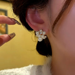 Close-up detail of the sparkling zircons and plating on the Flower Bud Earrings