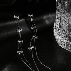 Angled view of the 14K Gold-Plated Micro-Diamond Bow Long Tassel Earrings
