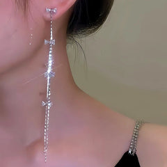 Model showcasing the dangle and style of the 14K Gold-Plated Micro-Diamond Bow Long Tassel Earrings