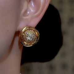 Gold round pave crystal stud earring worn on ear, side angle close-up