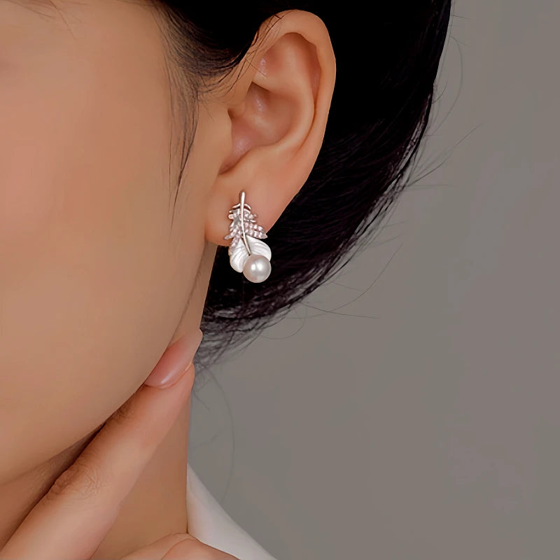 Model showcasing the dangle and style of the 14K Gold-Plated Mother-Of-Pearl Earrings