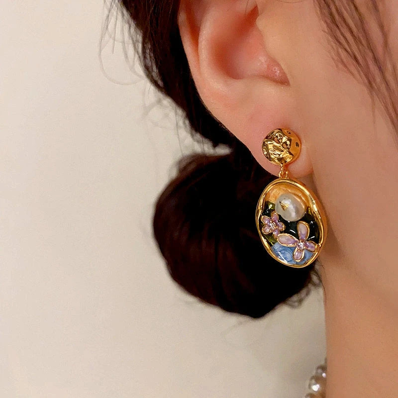 Model showcasing the dangle and style of the 14K Gold-Plated Oil-Dripping Freshwater Pearl Flower Oval Earrings