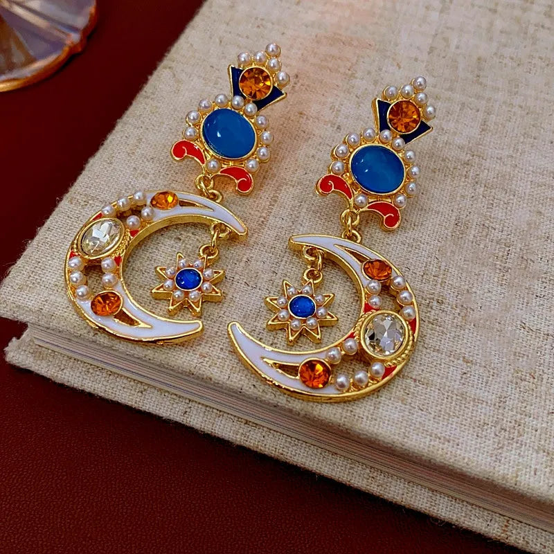 Model showcasing the dangle and style of the 14K Gold-Plated Oil-Drop Diamond Moon Star Flower Pearl Earrings