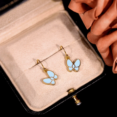Angled view of the 14K Gold-Plated Oil Drop Blue Butterfly Ear Hooks