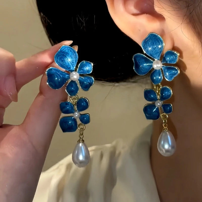 Model showcasing the dangle and style of the 14K Gold-Plated Oil Drop Flower Earrings