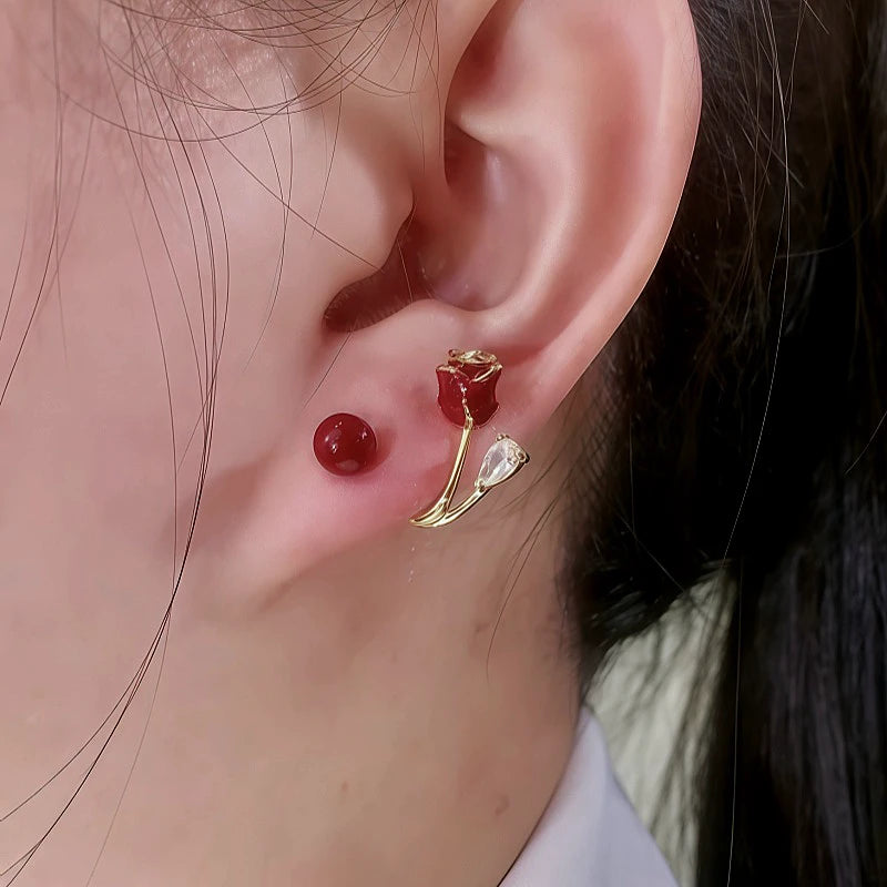 Close Up of Red Rose Red Bead Gold Dangle Stud Earrings on Ear