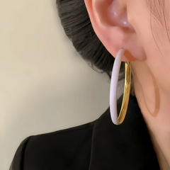 Model showcasing the dangle and style of the 14K Gold-Plated Oil Drop Hoop Earrings