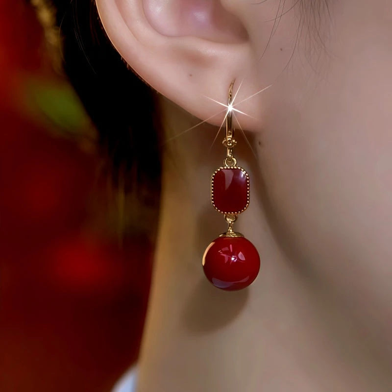 Model showcasing the dangle and style of the 14K Gold-Plated Oil Drop Pearl Earrings