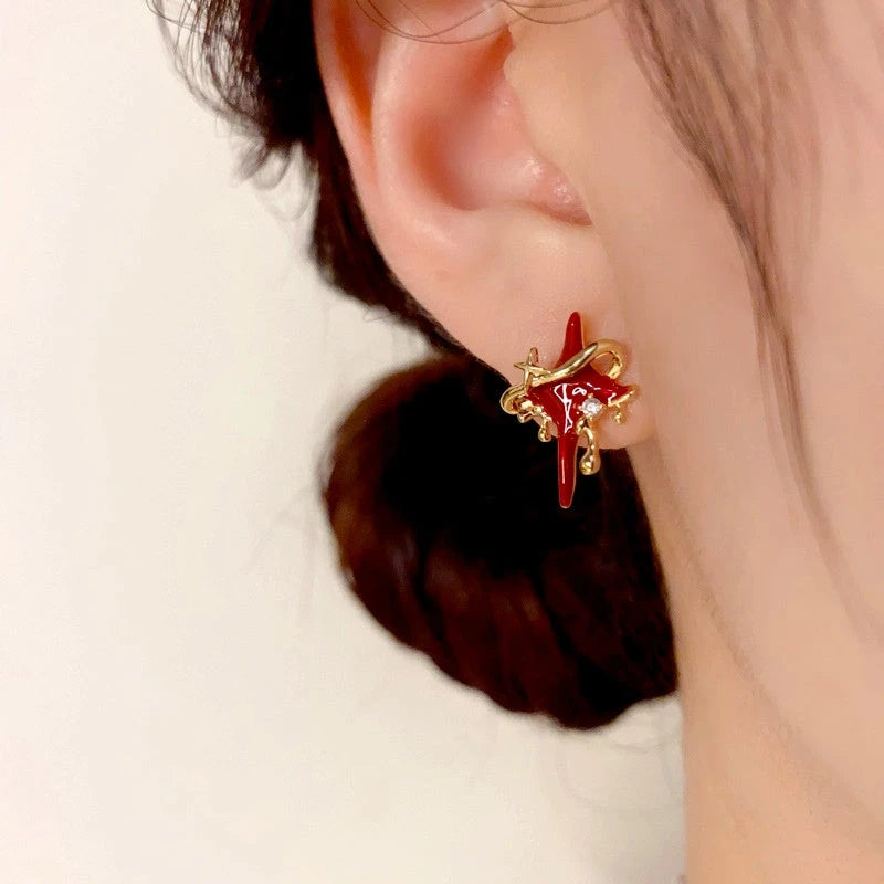 Model showcasing the dangle and style of the 14K Gold-Plated Oil Drop Star Stud Earrings