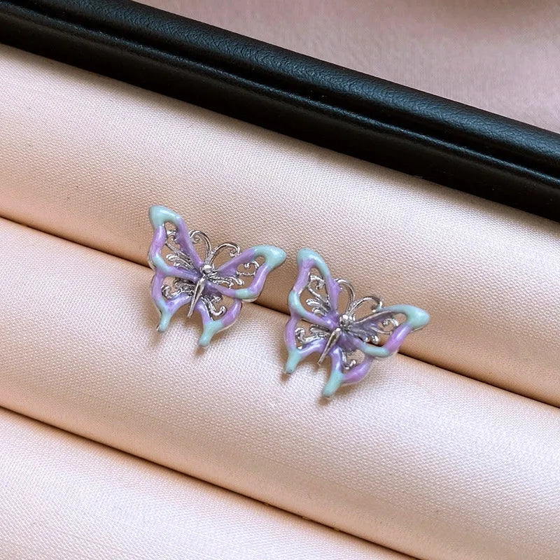 Pair of silver butterfly stud earrings with purple and mint green enamel