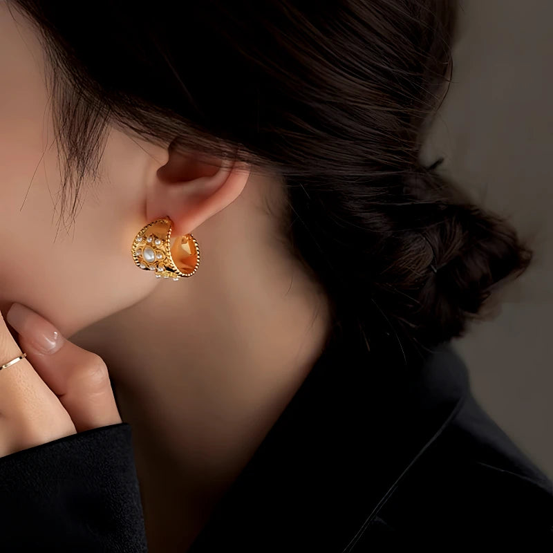 Model showcasing the dangle and style of the 14K Gold-Plated Pearl C-Shaped Earrings