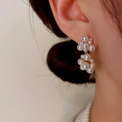 Model showcasing the dangle and style of the 14K Gold-Plated Pearl Earrings