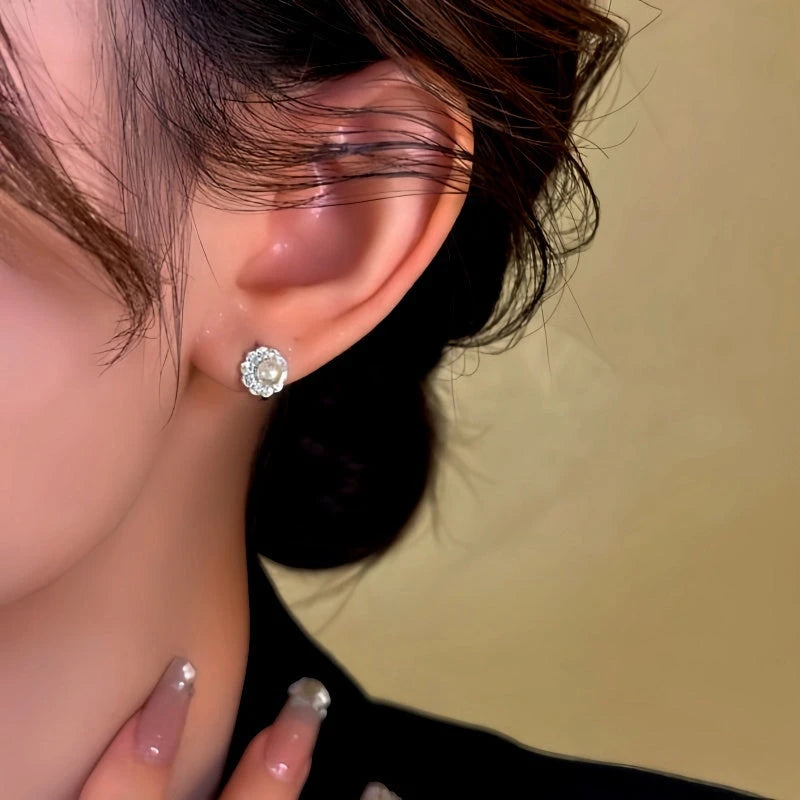 Model showcasing the dangle and style of the 14K Gold-Plated Pearl Flower Earrings