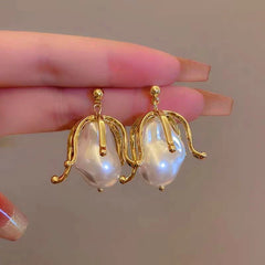 Angled view of the 14K Gold-Plated Pearl Flower Earrings