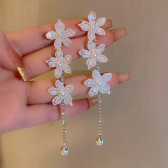 Angled view of the 14K Gold-Plated Pearl Flower Tassel Earrings