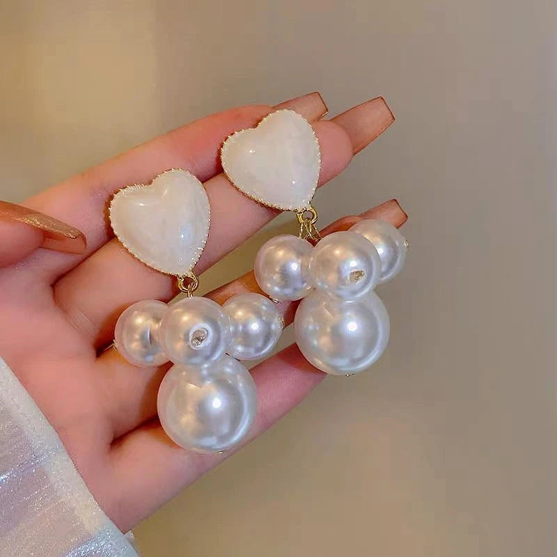 Angled view of the 14K Gold-Plated Pearl Heart Earrings